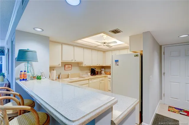 a kitchen with stainless steel appliances granite countertop a sink and cabinets