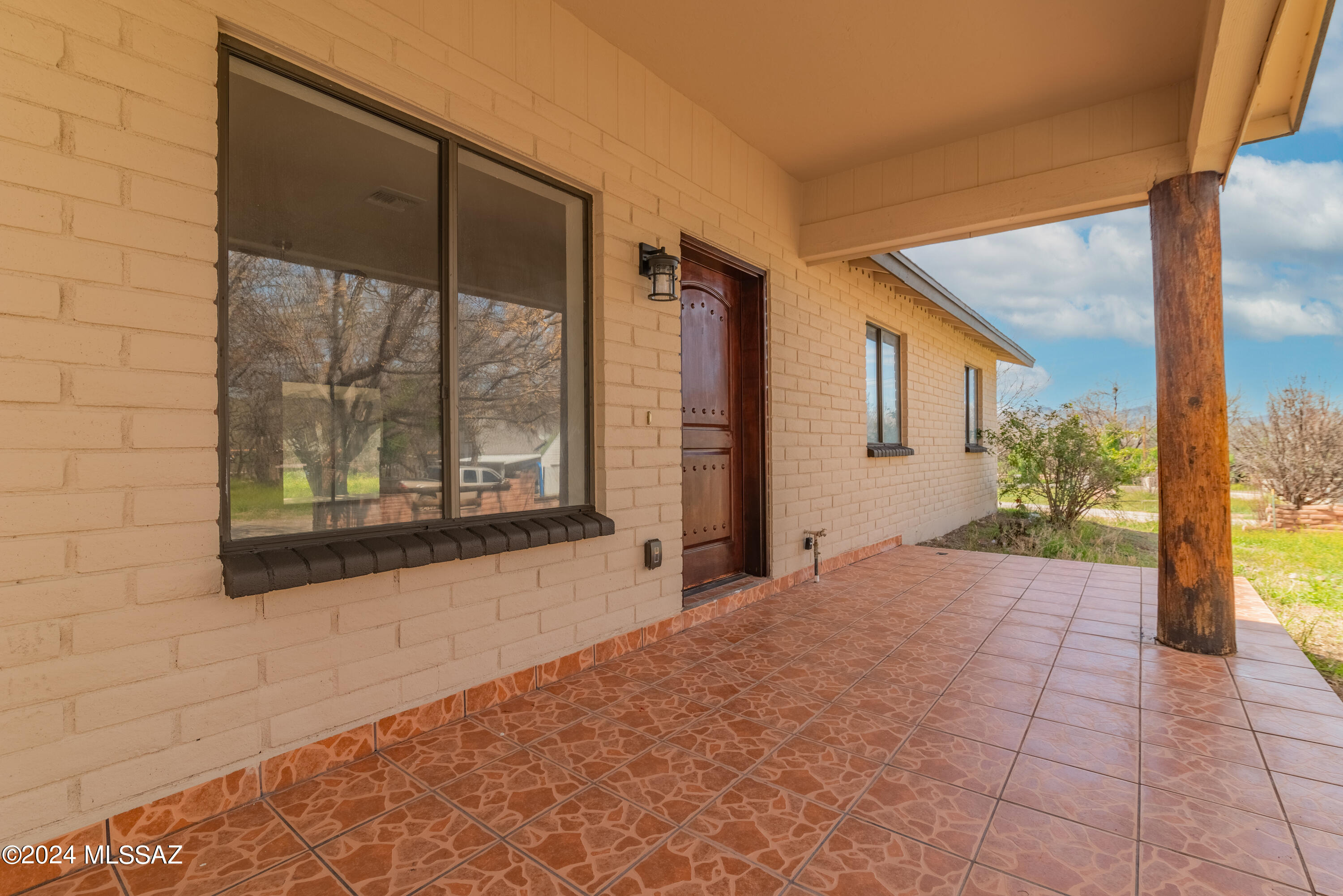 273 Harpo Court Rio Rico, AZ 85648 - Photo 5 of 34 a view of porch with a floor to ceiling window and potted plants