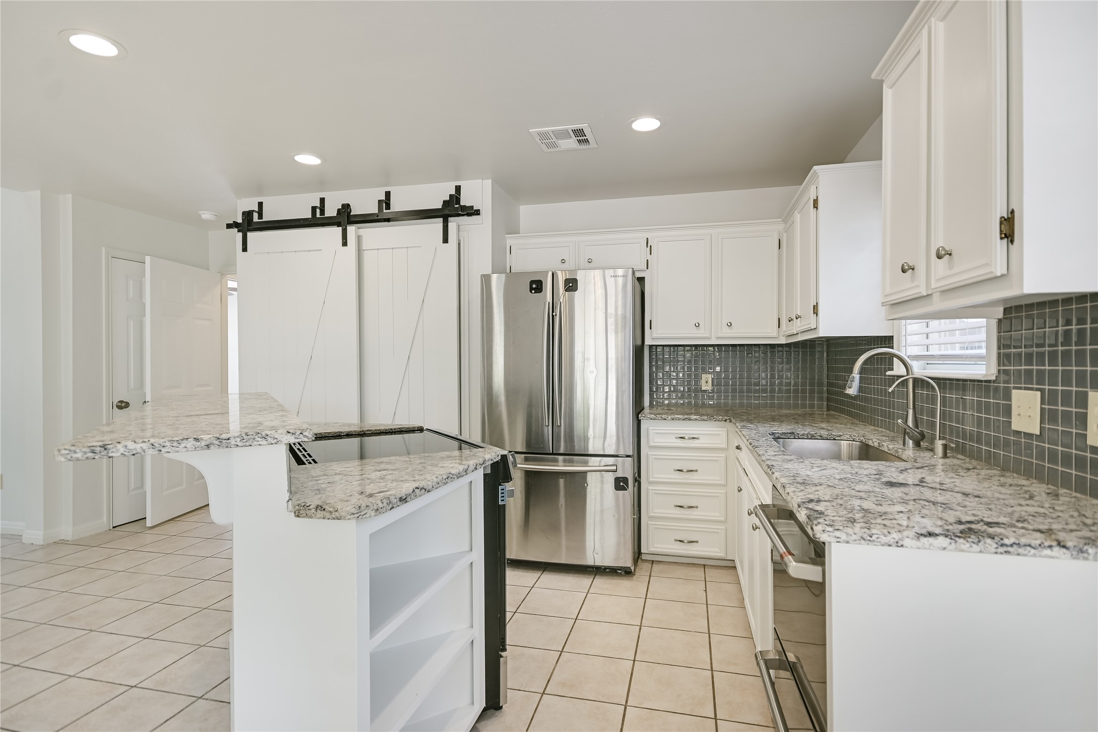 104 Crazy Cross Road Wimberley, TX 78676 - Photo 8 of 20 Polished granite countertops and classic tile flooring define this bright, efficient culinary workspace.