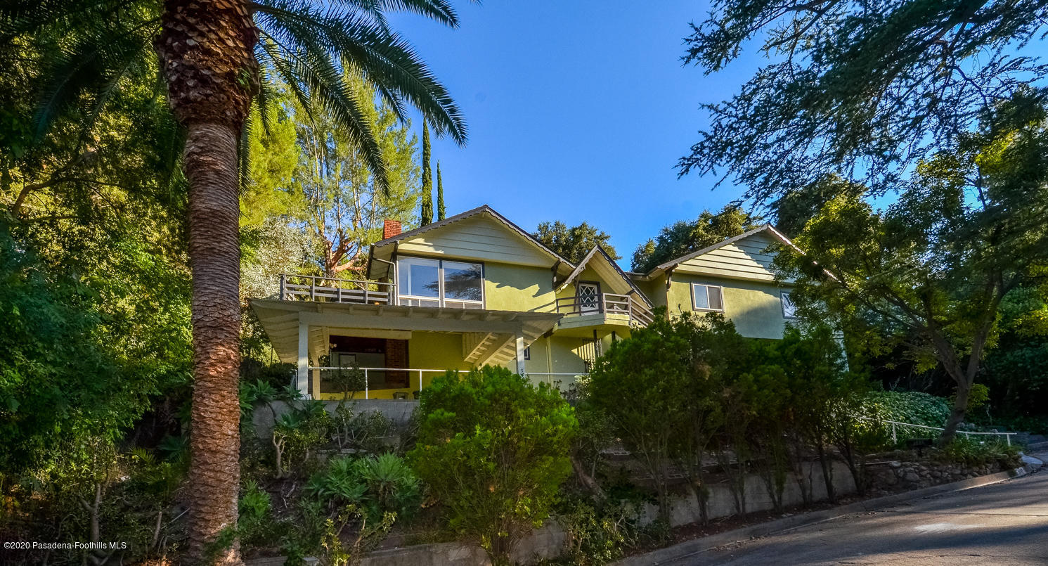 a front view of a house with yard and green space