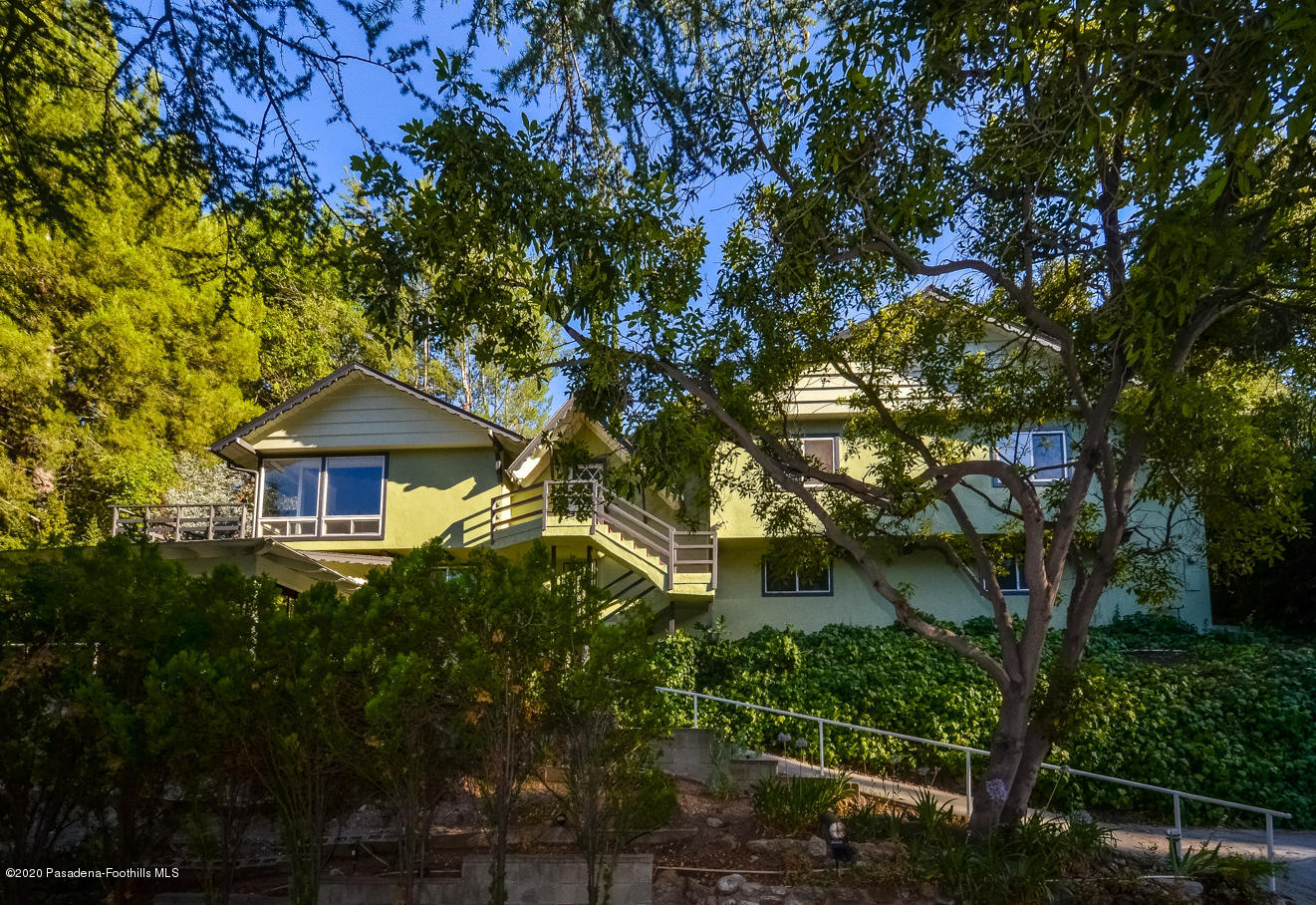 588 Glen Holly Drive Pasadena, CA 91105 - Photo 2 of 31 a yellow house with trees in front of it