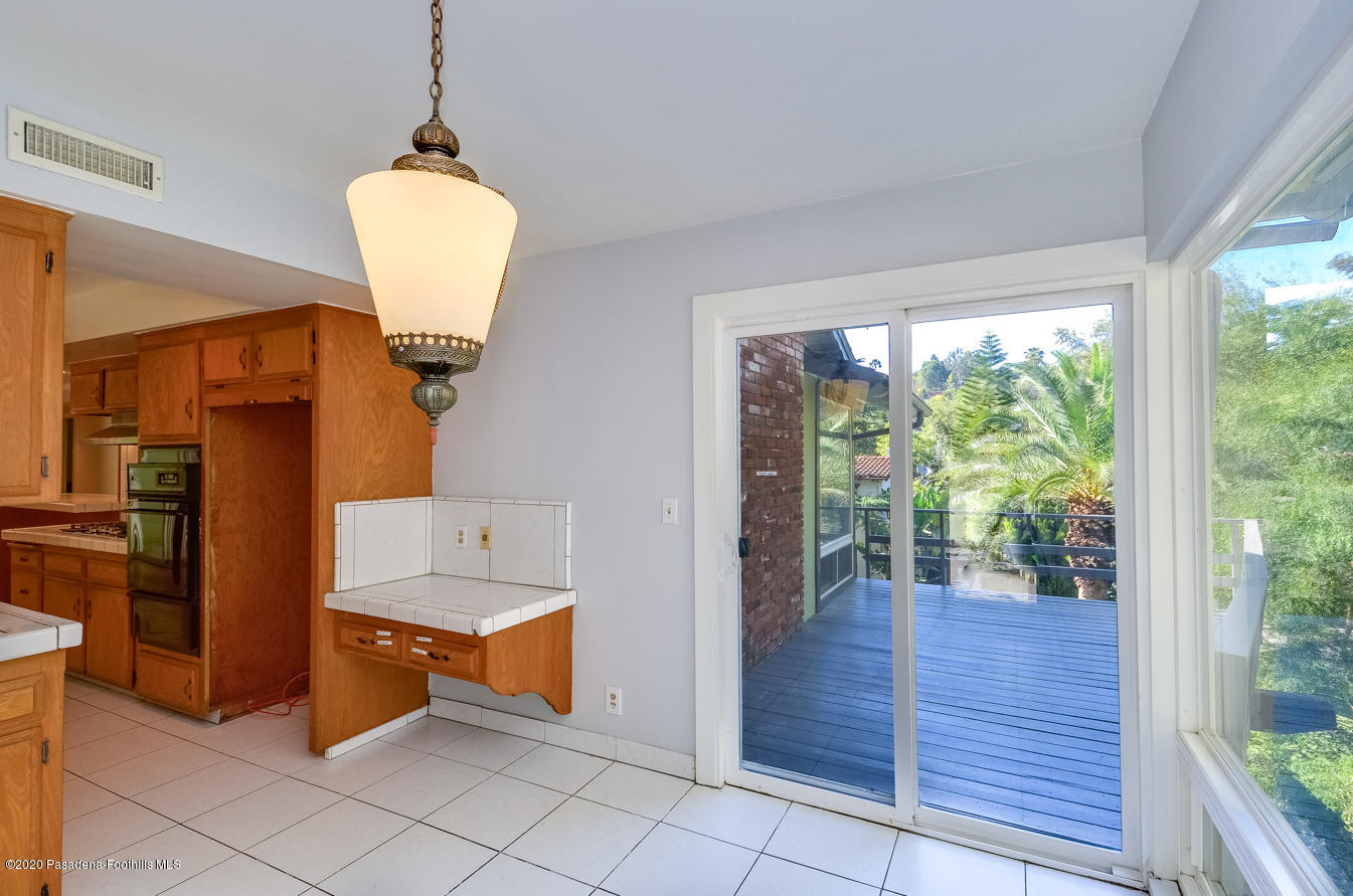 588 Glen Holly Drive Pasadena, CA 91105 - Photo 11 of 31 a room with wooden floor and a glass door