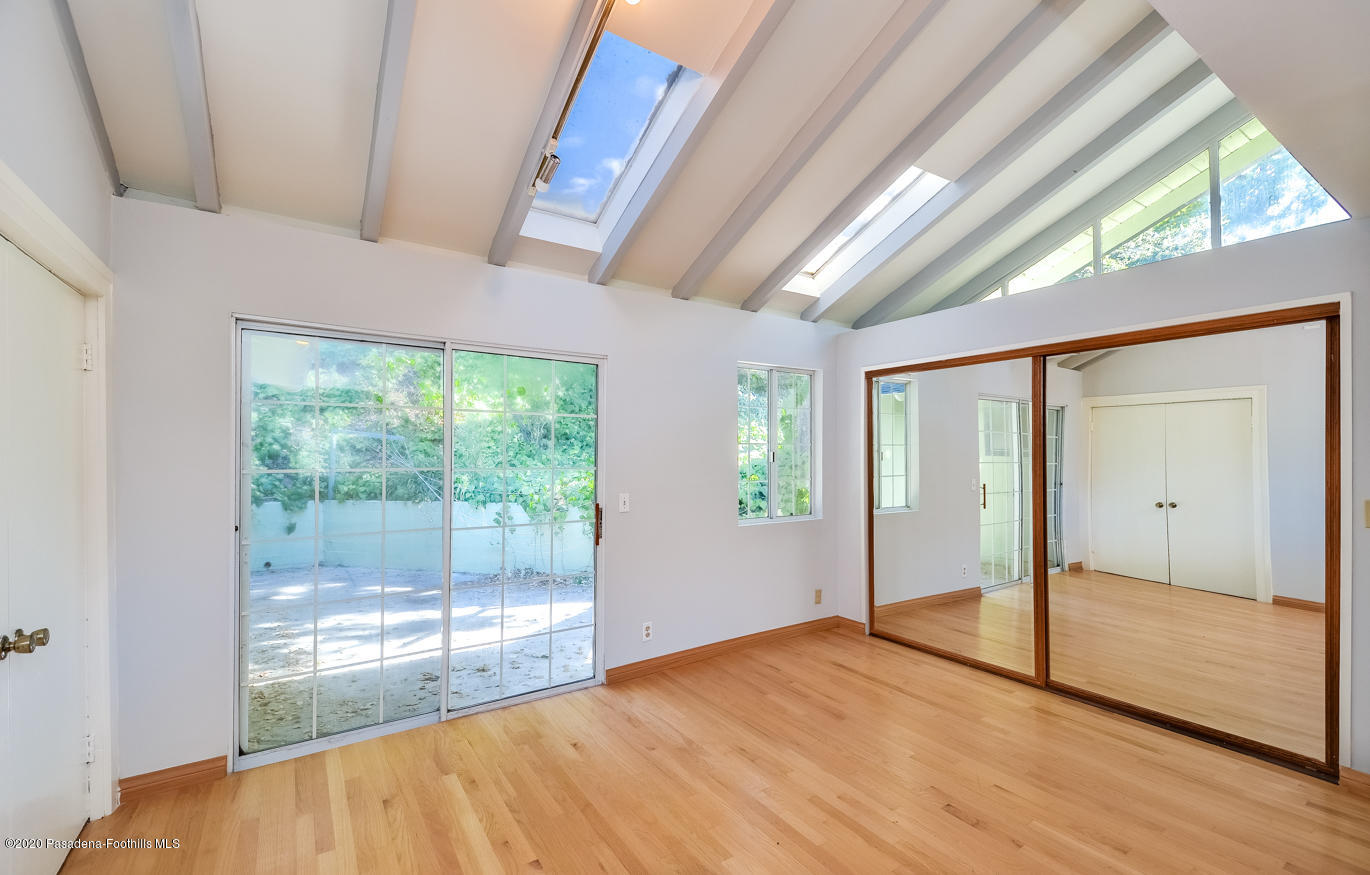 588 Glen Holly Drive Pasadena, CA 91105 - Photo 18 of 31 a view of empty room with wooden floor and fan