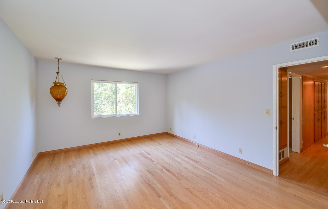 588 Glen Holly Drive Pasadena, CA 91105 - Photo 20 of 31 an empty room with wooden floor and window