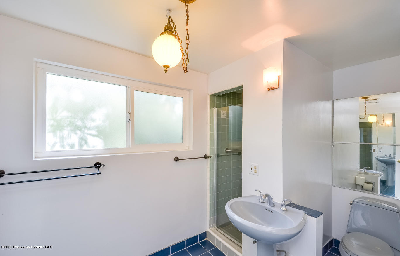 588 Glen Holly Drive Pasadena, CA 91105 - Photo 22 of 31 a bathroom with a sink mirror and toilet