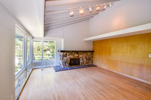 a kitchen with sink refrigerator and large window