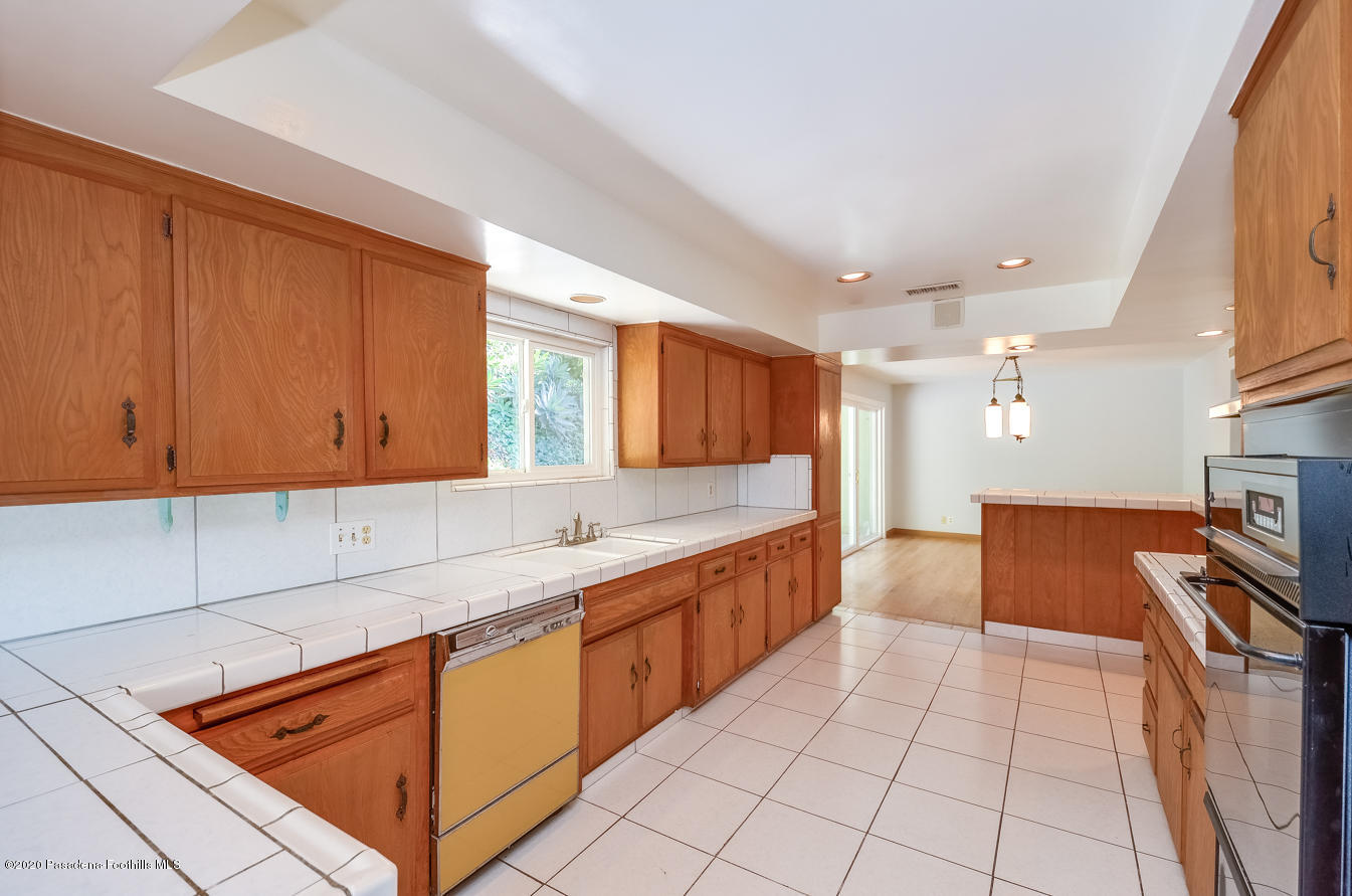 588 Glen Holly Drive Pasadena, CA 91105 - Photo 10 of 31 a kitchen with stainless steel appliances granite countertop a sink counter space and cabinets
