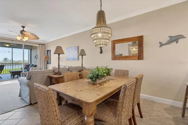 a view of a dining room with furniture wooden floor and chandelier
