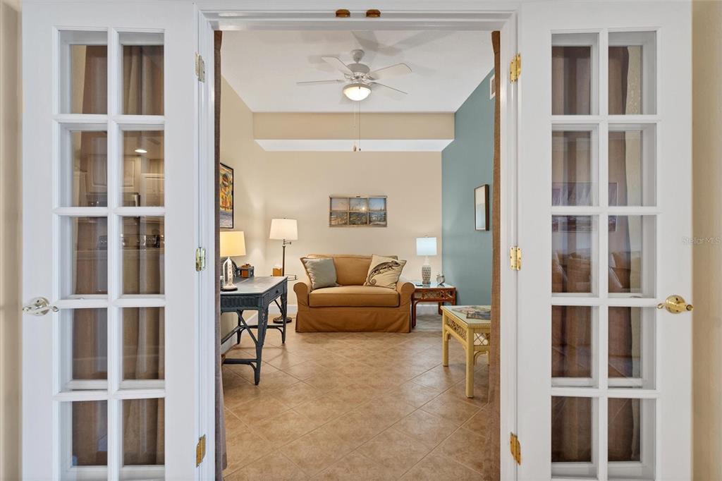 13313 Gasparilla Road, Unit 204 Placida, FL 33946 - Photo 12 of 28 a living room with furniture and a chandelier