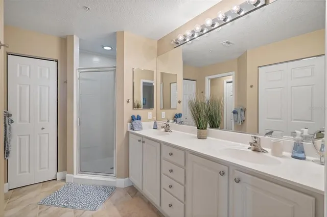 a spacious bathroom with a double vanity sink mirror and double