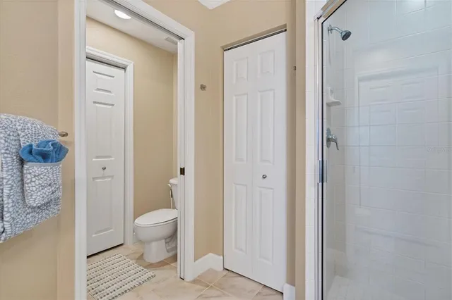 a bathroom with a granite countertop toilet a sink and a mirror