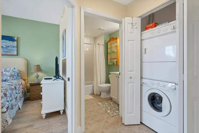 a view of a bedroom with washer and dryer