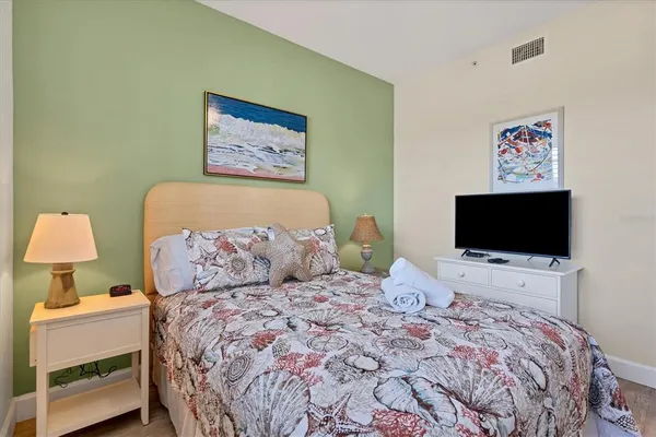 a bedroom with a bed and a television