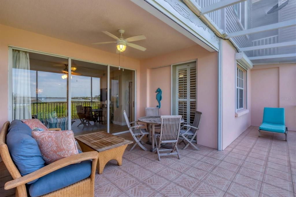 13313 Gasparilla Road, Unit 204 Placida, FL 33946 - Photo 22 of 28 a living room with furniture a flat screen tv and a large window