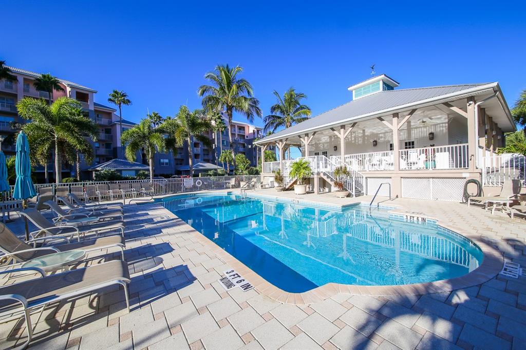 13313 Gasparilla Road, Unit 204 Placida, FL 33946 - Photo 25 of 28 a view of a swimming pool with sitting area