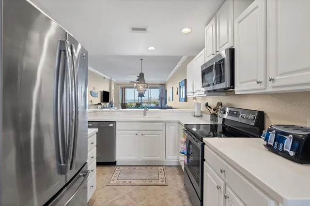 a kitchen with cabinets and stainless steel appliances