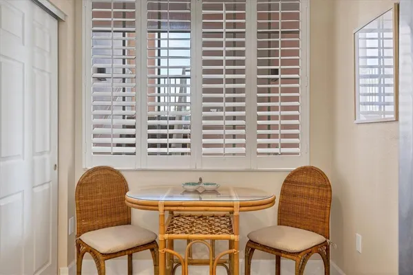 a view of a dining room with furniture and chandelier