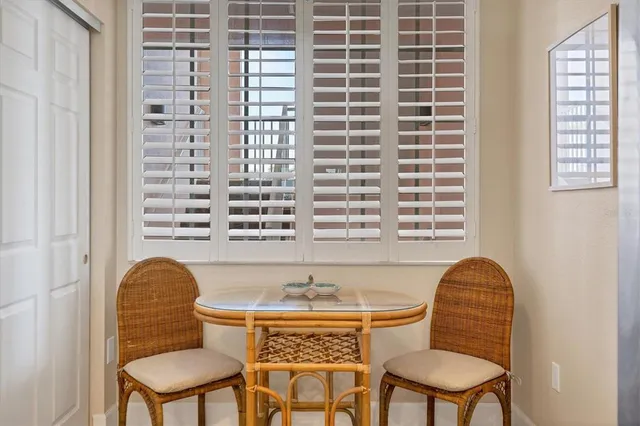 a view of a dining room with furniture and chandelier