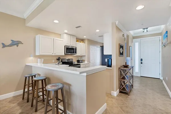 a kitchen with a table chairs refrigerator and microwave