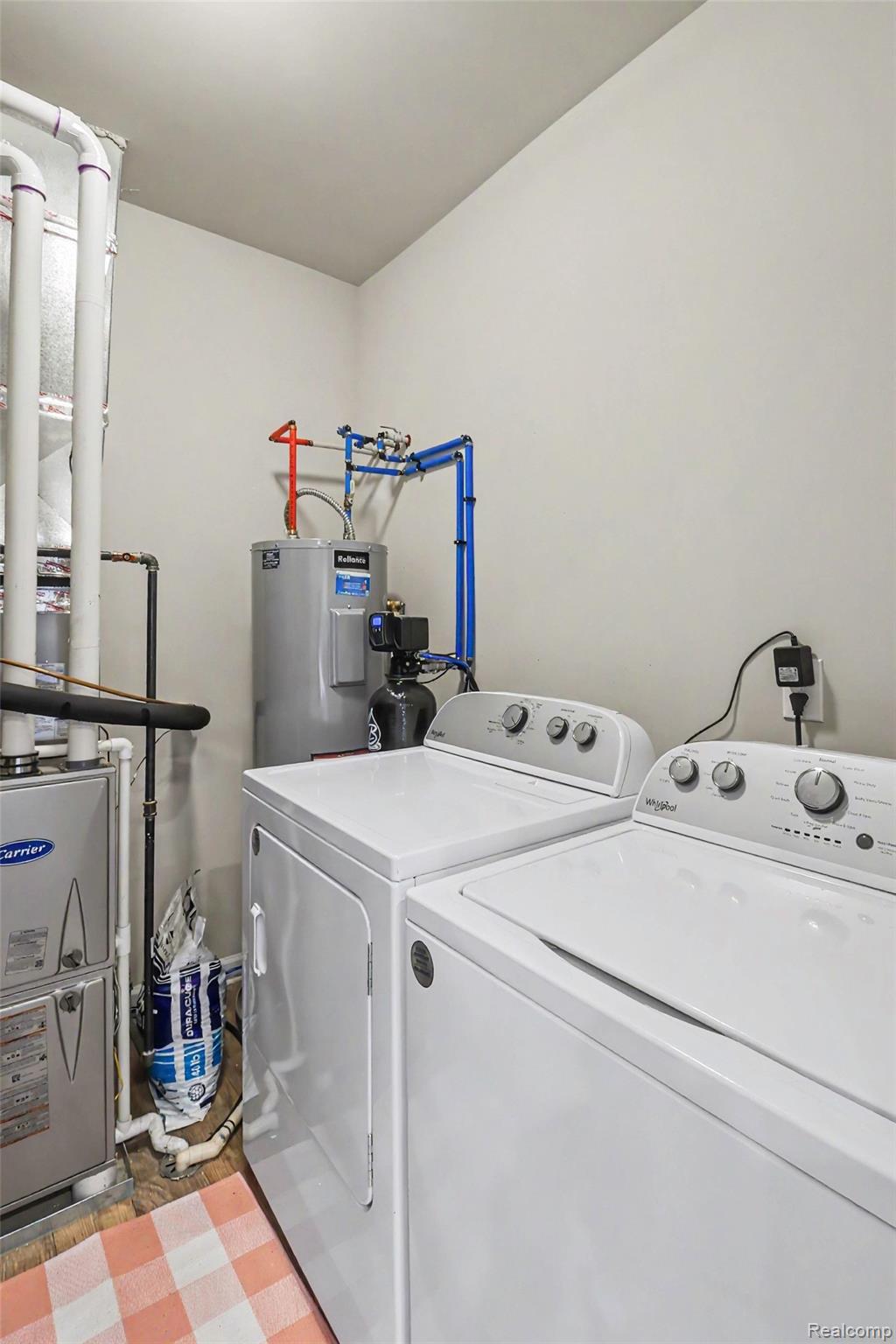 9864 Ridge Run Street Howell, MI 48855 - Photo 22 of 23 Laundry area with washer and dryer and water heater