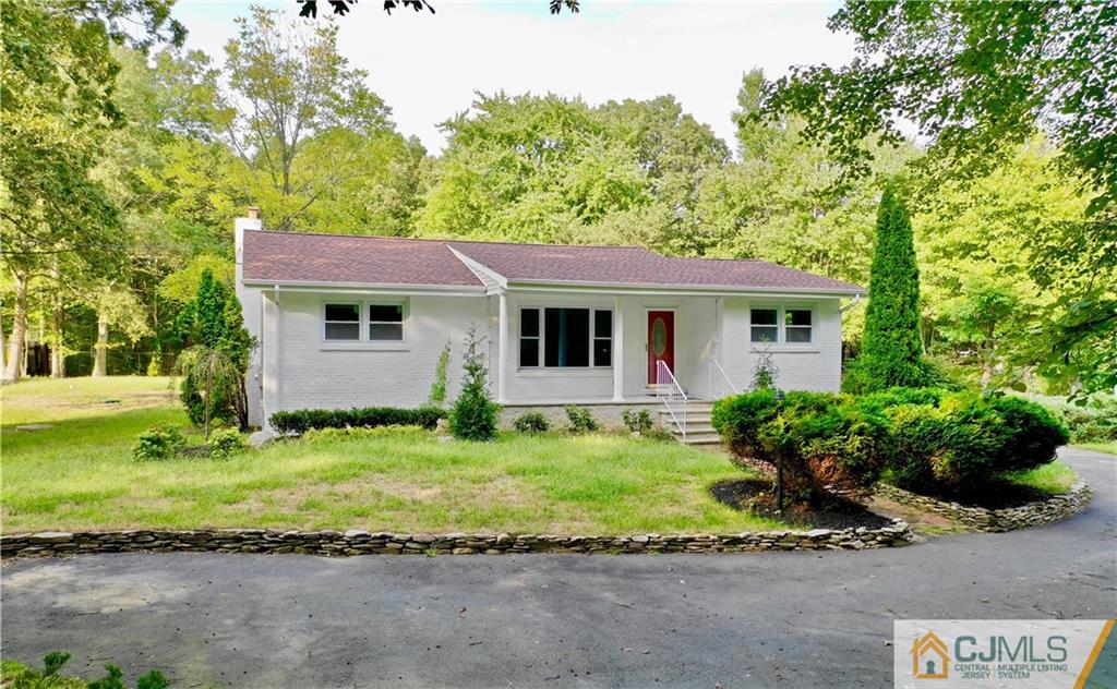 236 Spring Valley Road Morganville, NJ 07751 - Photo 2 of 23 a view of a yard in front of a house with a large tree