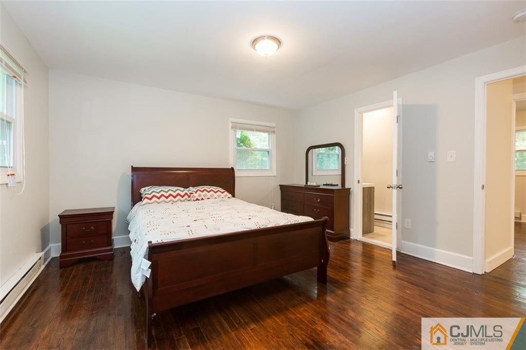 236 Spring Valley Road Morganville, NJ 07751 - Photo 13 of 23 a bedroom with a bed table and a window