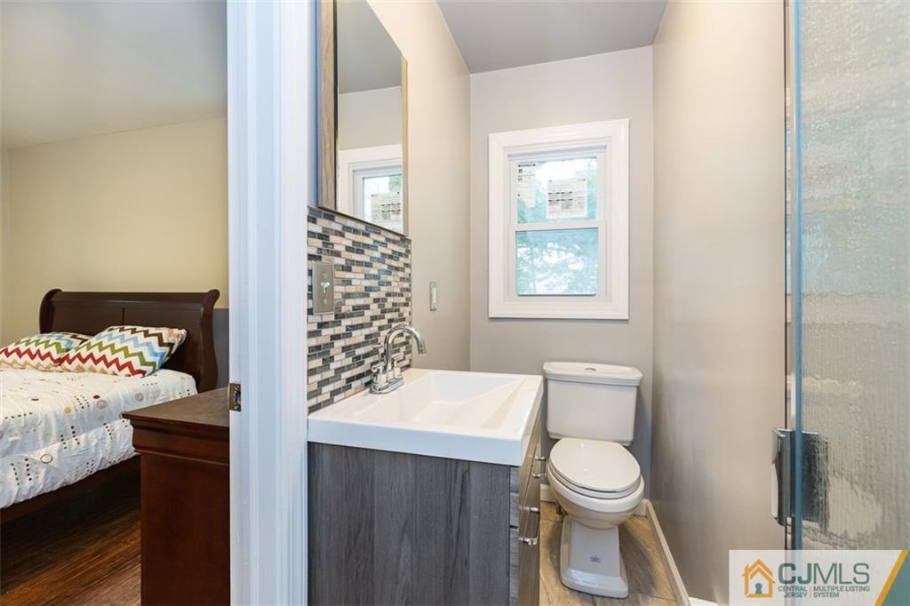 236 Spring Valley Road Morganville, NJ 07751 - Photo 14 of 23 a bathroom with a sink toilet and window