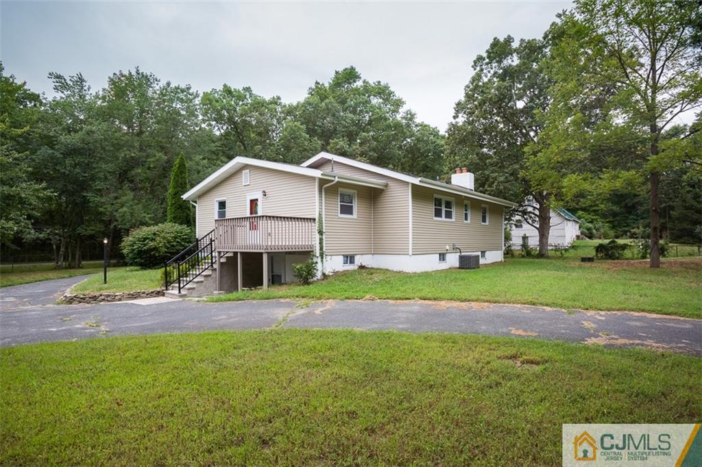 236 Spring Valley Road Morganville, NJ 07751 - Photo 17 of 23 a front view of a house with garden