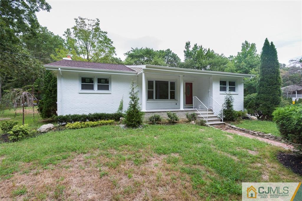 236 Spring Valley Road Morganville, NJ 07751 - Photo 18 of 23 a backyard of a house with potted plants and wooden fence