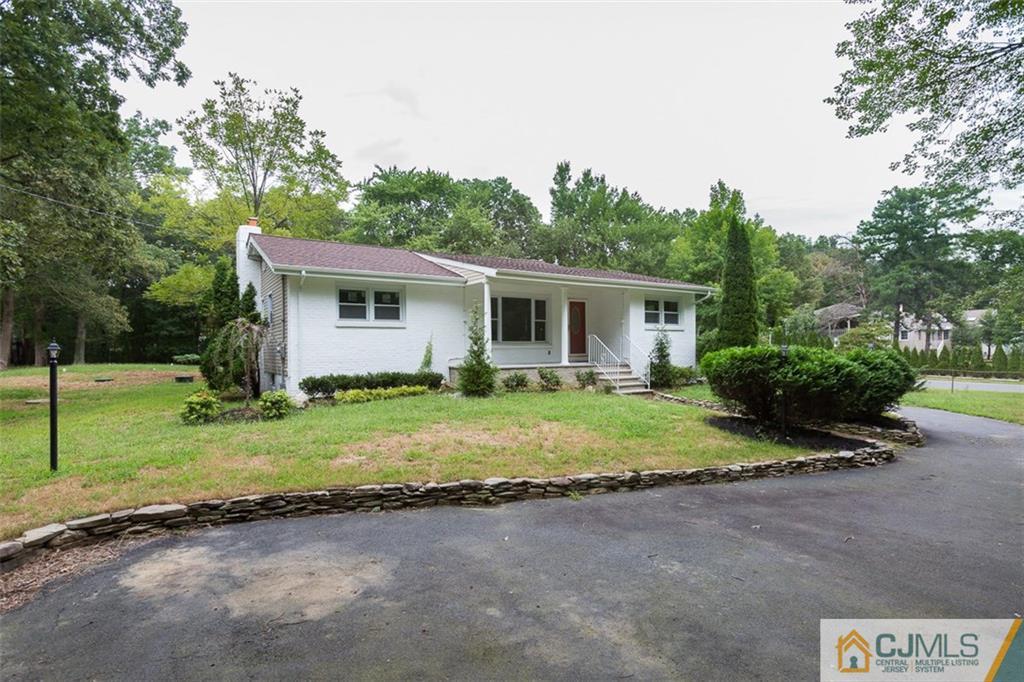 236 Spring Valley Road Morganville, NJ 07751 - Photo 19 of 23 a view of a house with backyard and trees
