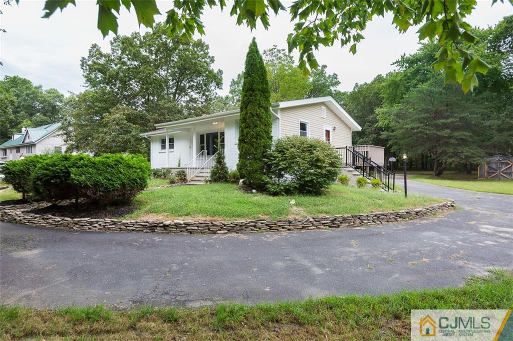 236 Spring Valley Road Morganville, NJ 07751 - Photo 20 of 23 a view of a house with a backyard