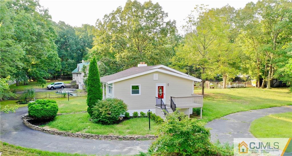 236 Spring Valley Road Morganville, NJ 07751 - Photo 21 of 23 a front view of a house with garden
