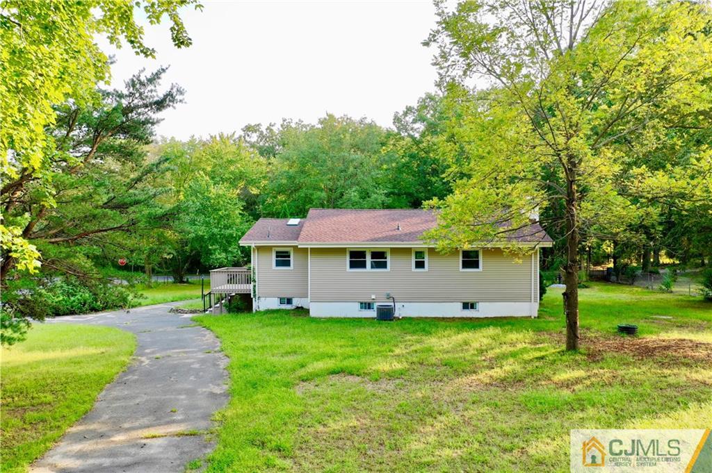 236 Spring Valley Road Morganville, NJ 07751 - Photo 23 of 23 a view of a house with a yard and sitting area