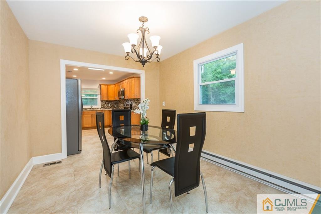 236 Spring Valley Road Morganville, NJ 07751 - Photo 6 of 23 a view of a dining room with furniture and a chandelier
