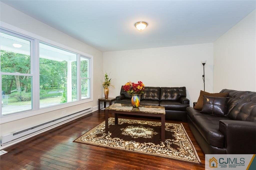 236 Spring Valley Road Morganville, NJ 07751 - Photo 7 of 23 a living room with furniture and a rug