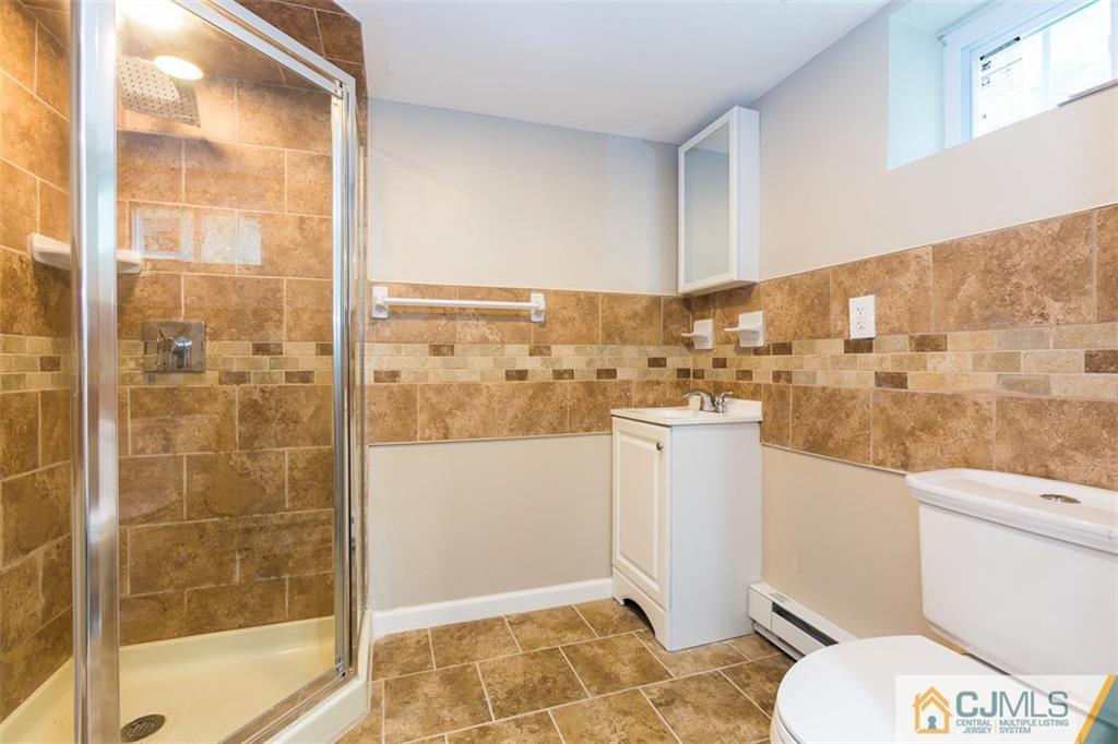 236 Spring Valley Road Morganville, NJ 07751 - Photo 8 of 23 a bathroom with a toilet and a shower