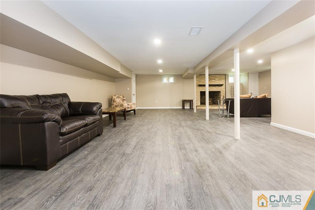 236 Spring Valley Road Morganville, NJ 07751 - Photo 9 of 23 a living room with furniture and a wooden floor