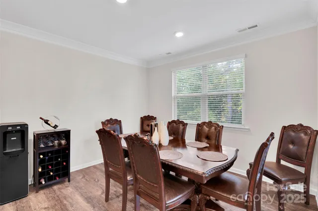 a dining room with furniture a wooden floor and chandelier