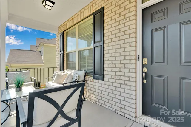 a balcony view with a seating space