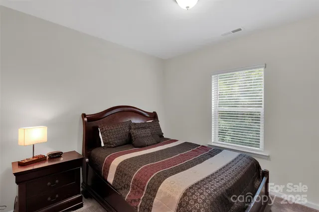 a bedroom with a bed and a television