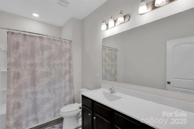 a spacious bedroom with a bed and a window