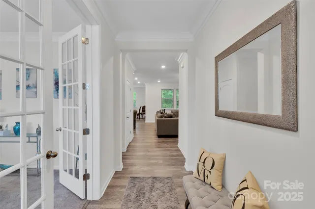 a work room with furniture a rug and a window