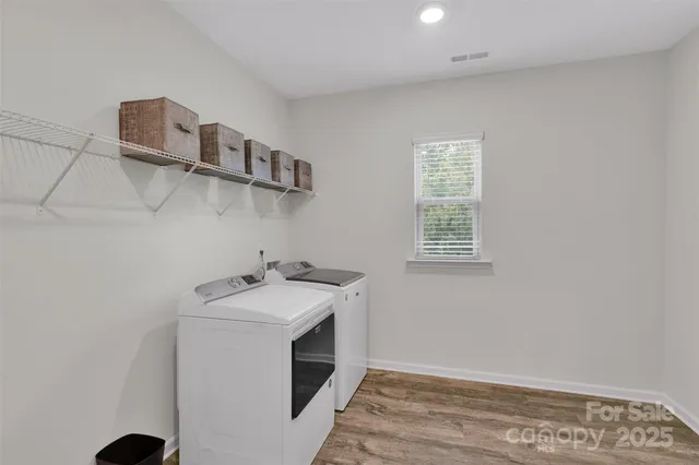 a kitchen with a stove and a wooden floor