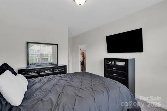 a bedroom with a bed and a table