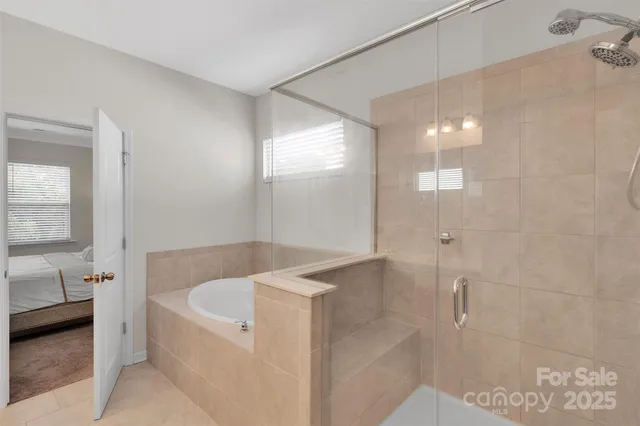 a view of walk in closet with clothes