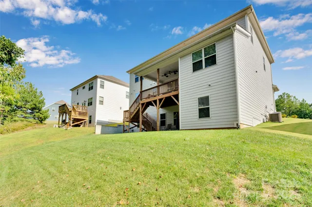 a view of patio with couple of chairs and potted plants