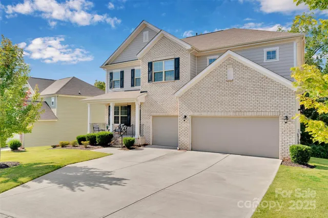 a front view of a house with a yard garage and outdoor seating