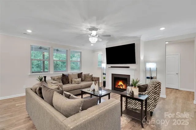 a living room with furniture a fireplace and a flat screen tv