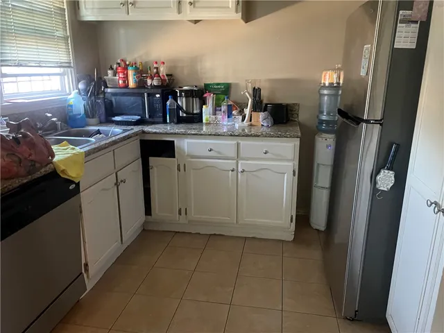 a utility room with cabinets washer and dryer