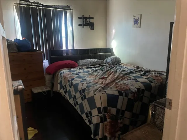 a bed sitting in a bedroom next to a window